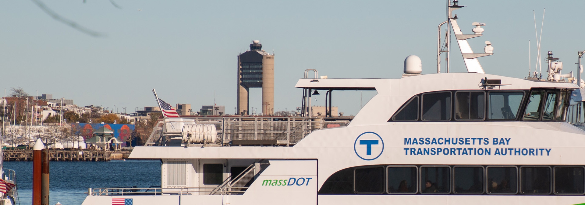 Ferry with airport control tower in the background