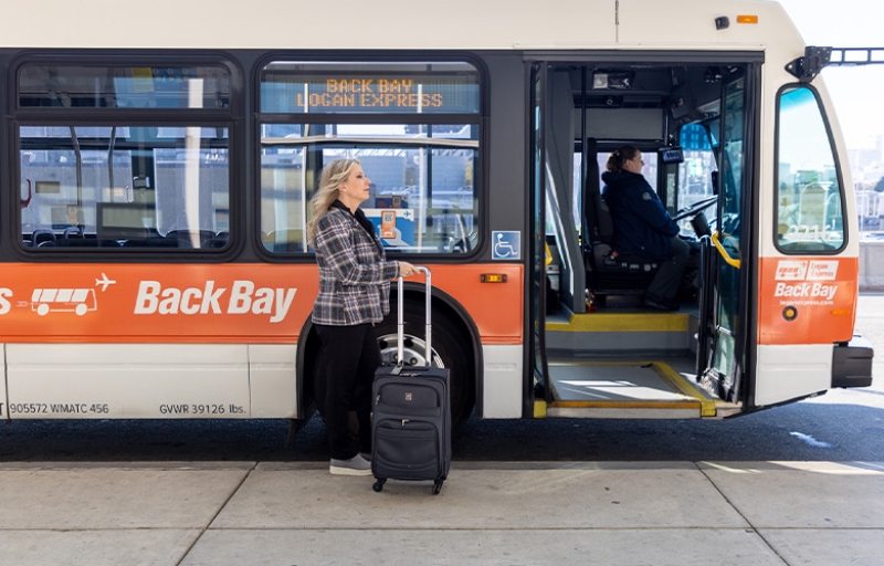 Traveler walking past Back Bay Logan Express