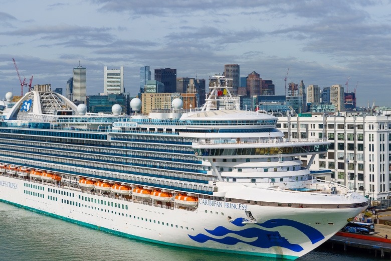 Cruise ships with city in background