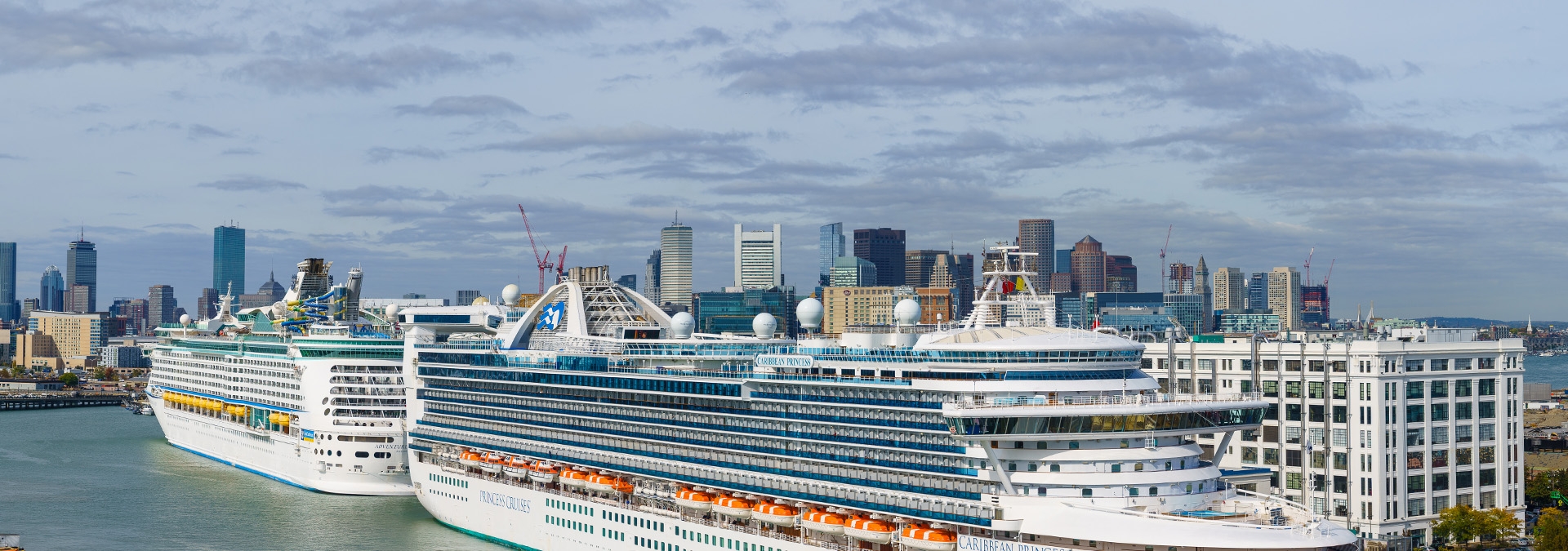 Cruise ships with city in background