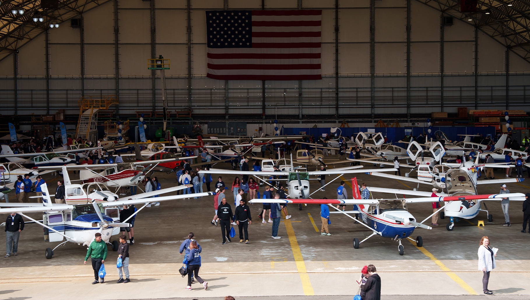 people looking at planes in Delta hanger for the STEM expo