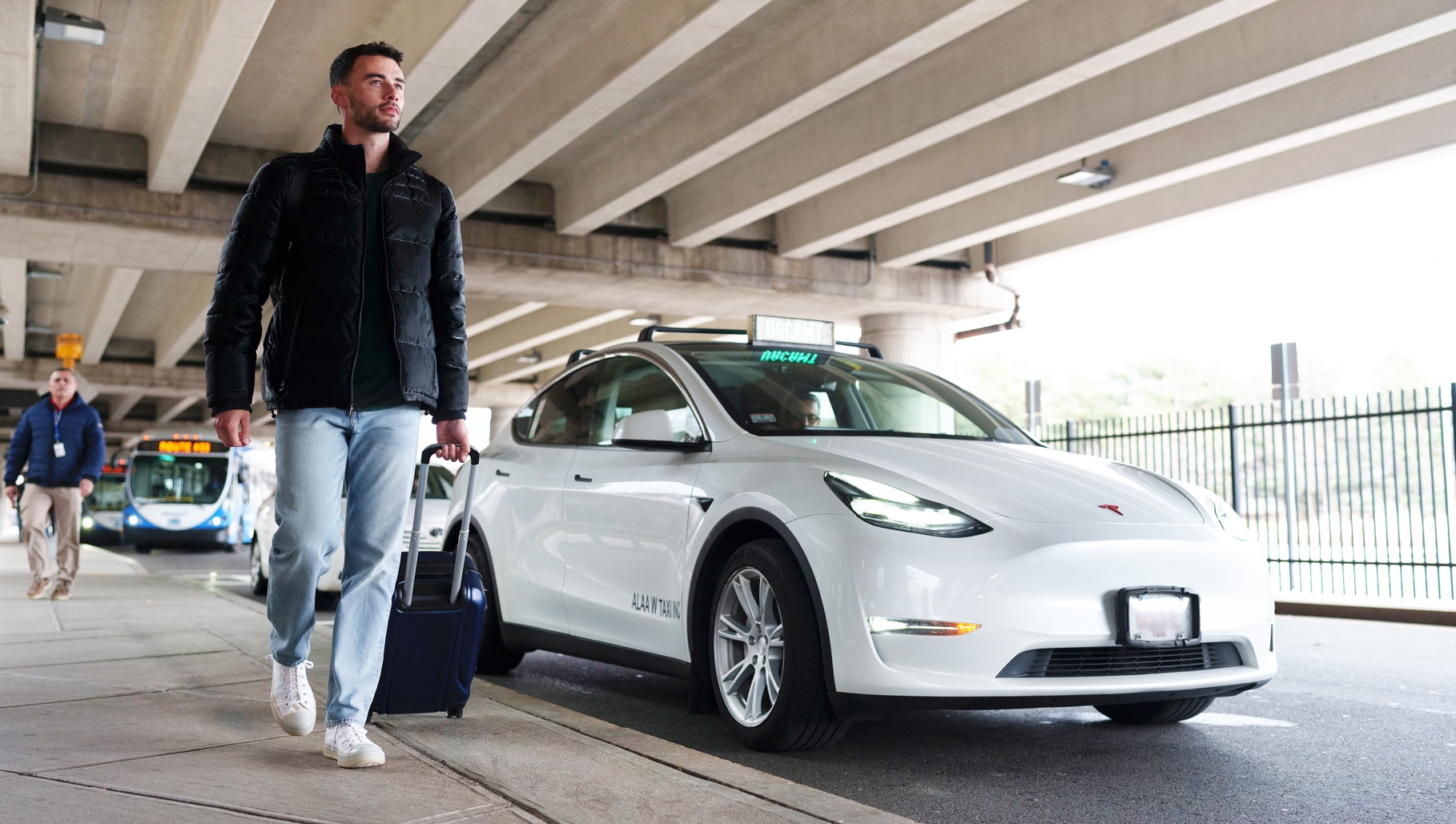 Man walking next to tesla taxi