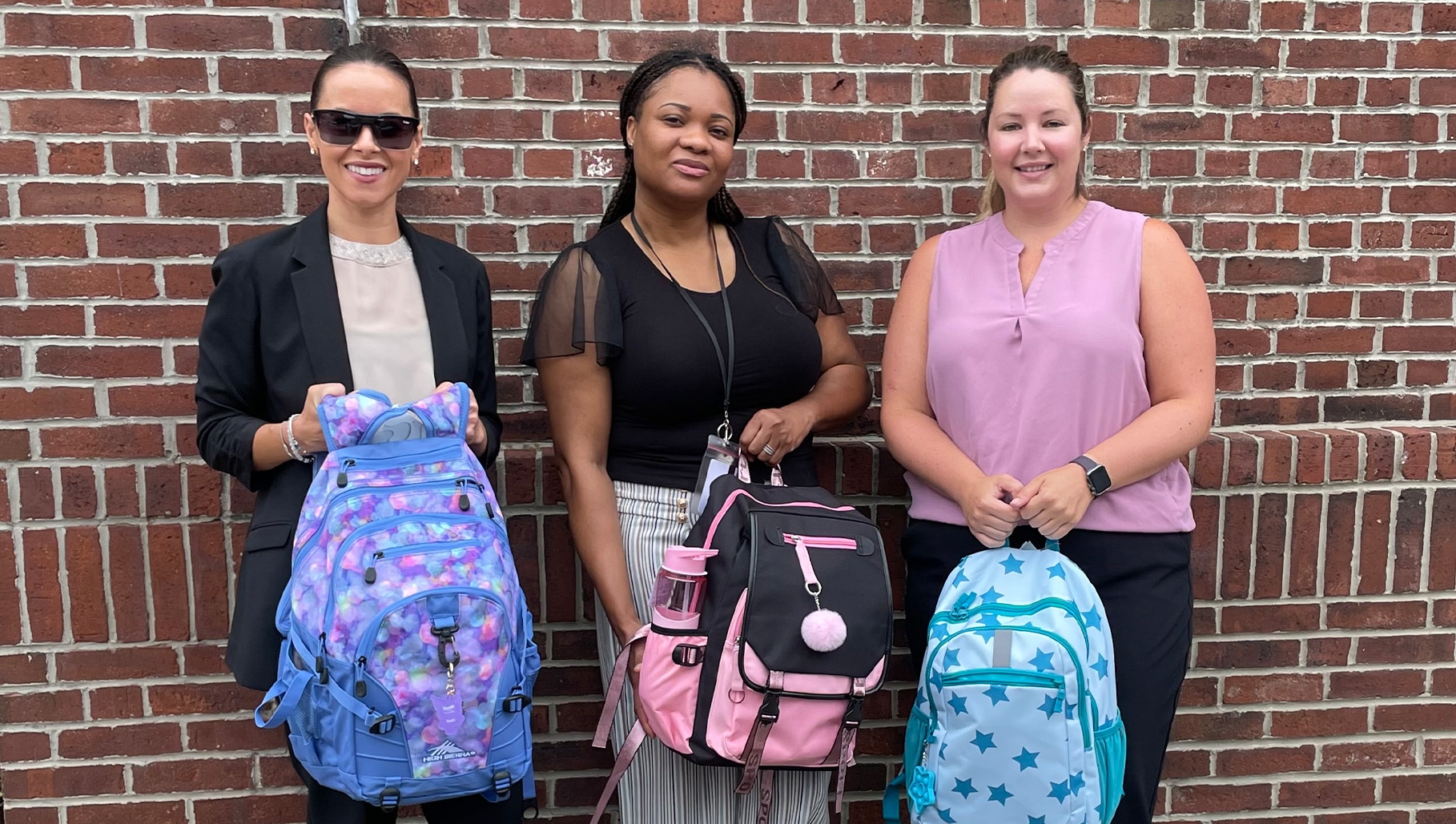 People holding backpacks