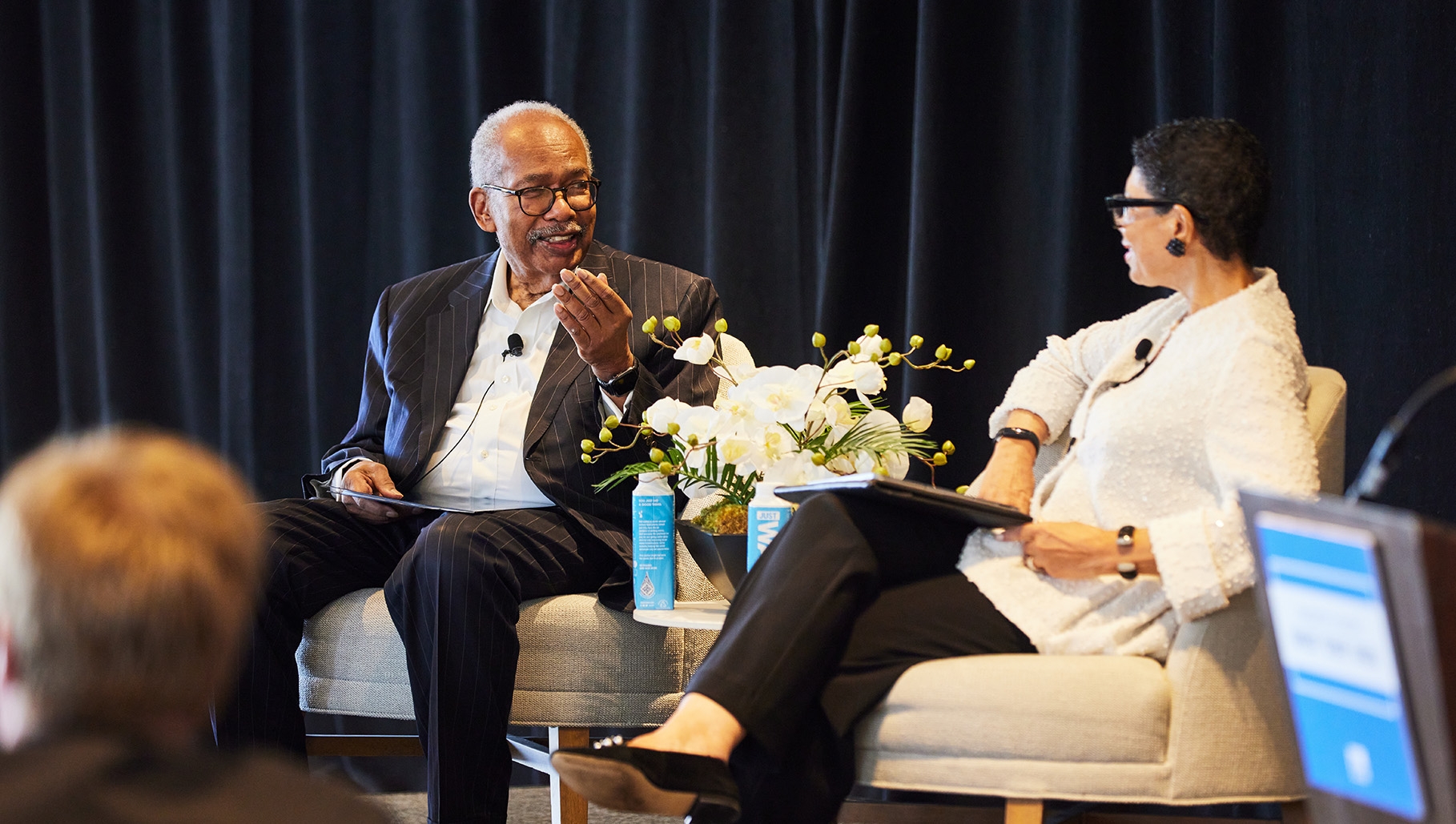 Two people talking on stage