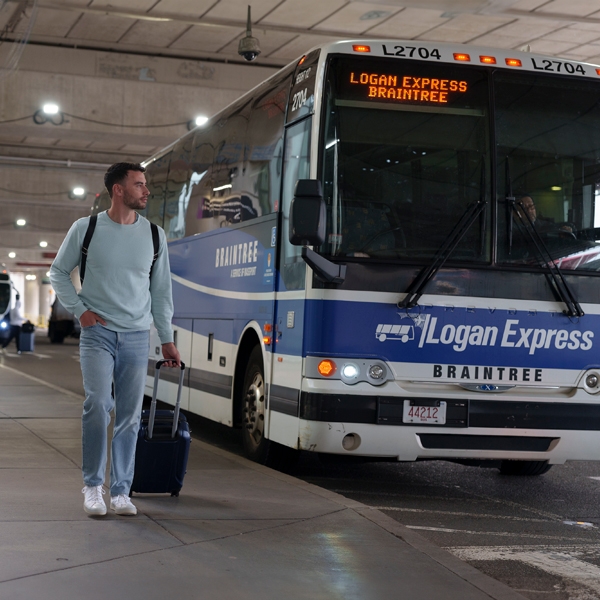 Man walking to airport from Logan Express bus