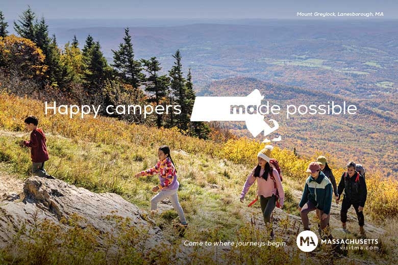 People hiking up mountain in the fall