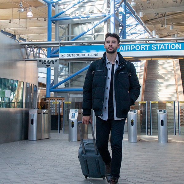 Man walking through airport station