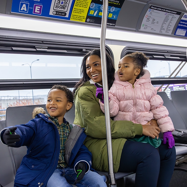 Kids on bus with jackets and gloves