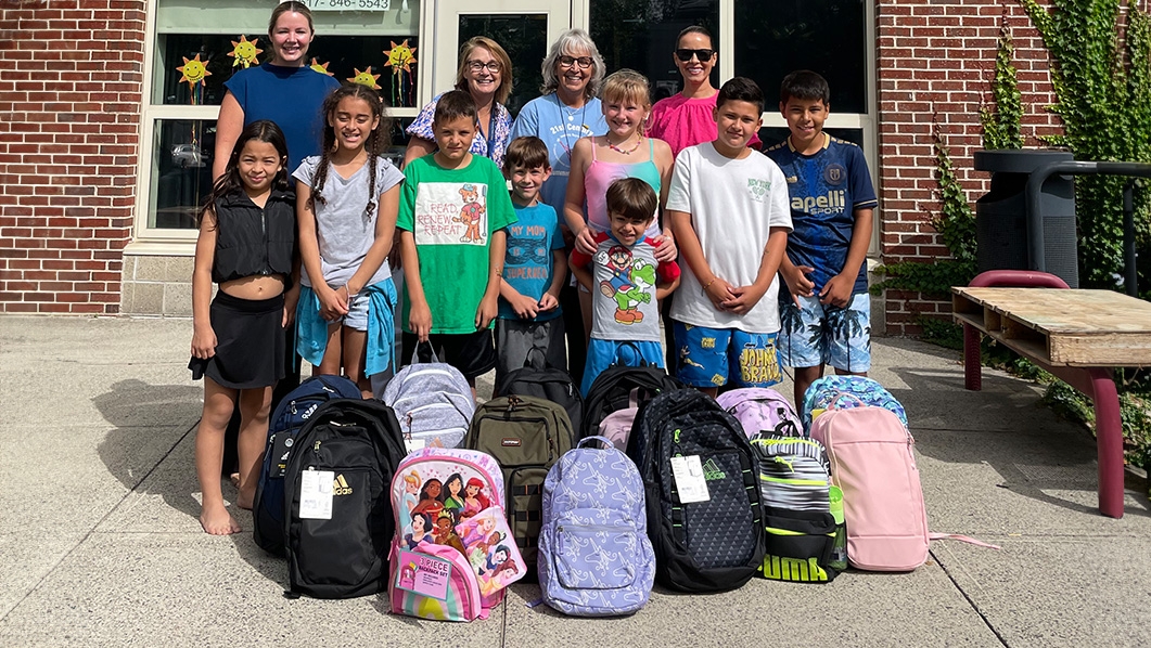 Massport employees donating backpacks