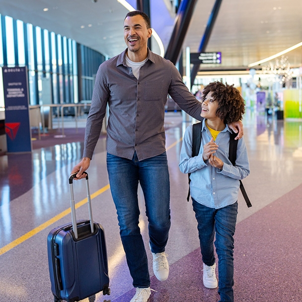 Father and son walking through terminal E