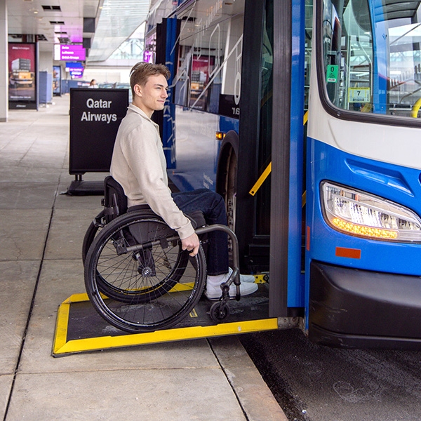 Man in wheelchair getting on bus